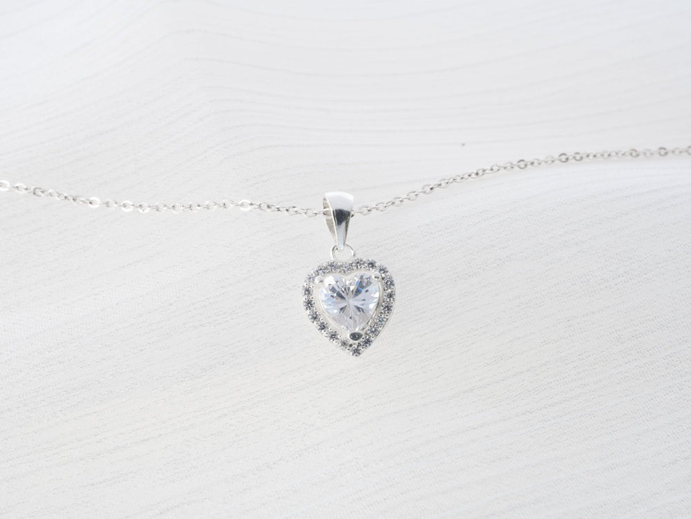Guardian Heart Necklace Silver, một viên đá trắng hình trái tim viền quanh hàng đá nhỏ