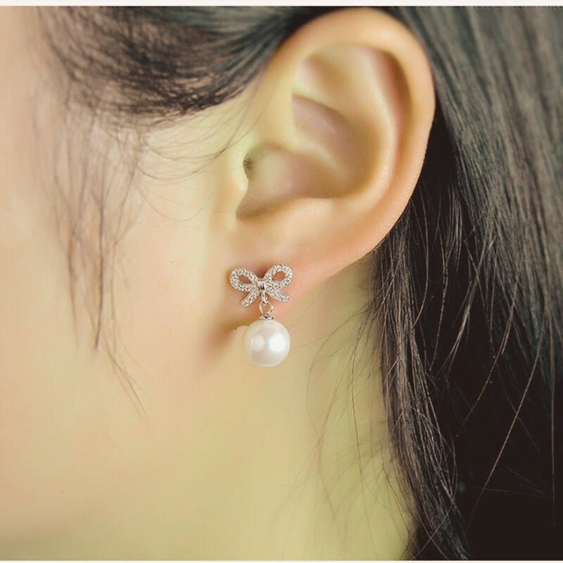 Bow-shaped and Synthetic Pearl Earrings - 3101SV